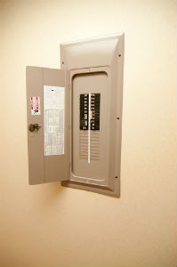 A circuit breaker panel in a white wall