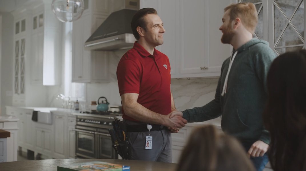 Friendly Black Diamond Technician Shaking Hands with Homeowners - Top-Rated Service