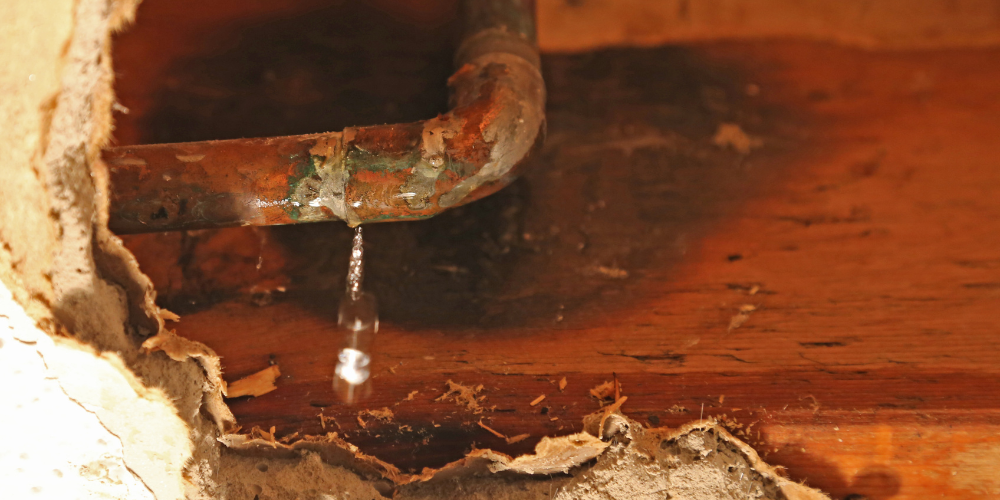 Rusty corroded aging plumbing pipe that is leaking water - How Can I Tell if I Have a Hidden Plumbing Leak? - Black Diamond Plumbing & Mechanical